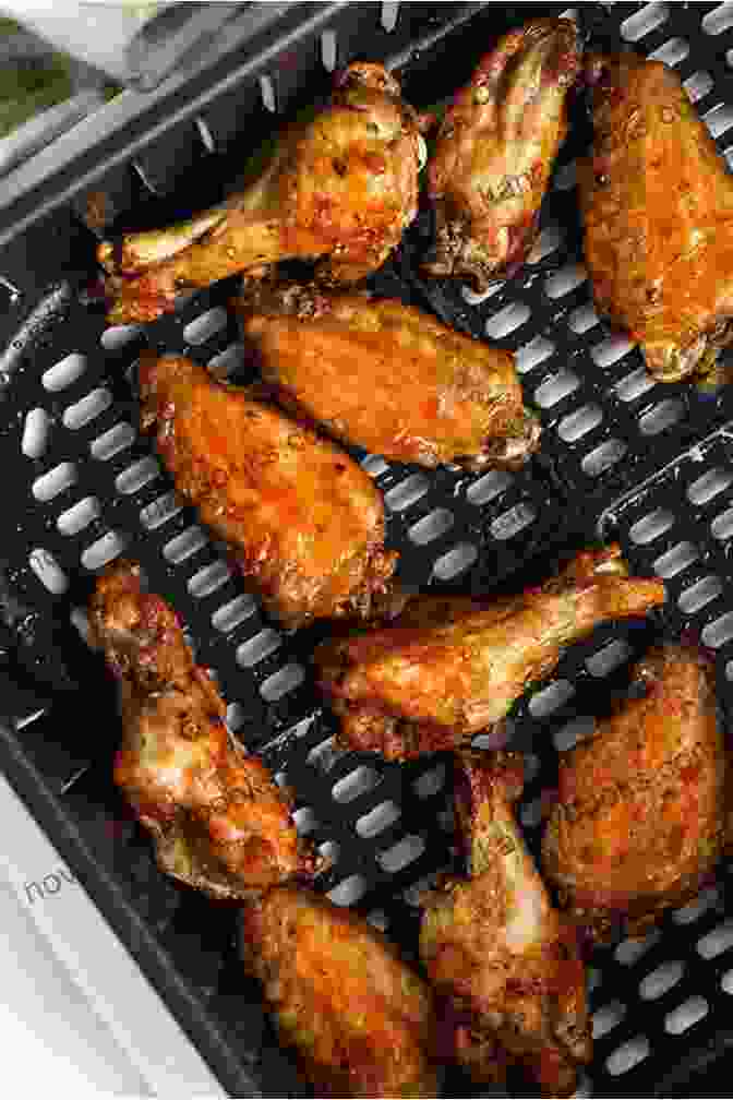 Golden Brown Chicken Wings Cooked In The Air Fryer, Ready To Tantalize Your Taste Buds. Air Fryer Cookbook: A Beginner`s Guide Including The Best 120 Quick Easy Recipes For Your Air Fryer